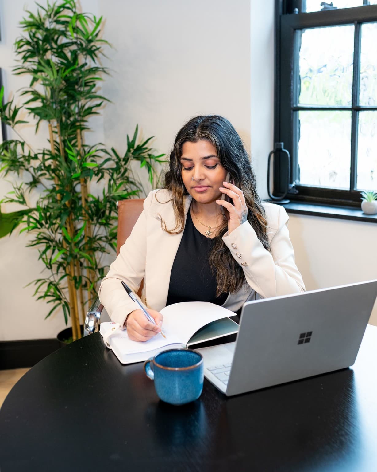 Priyanka Ayodele, founder of The Leadership Method, working at her laptop